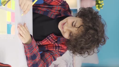 Child Drawing at Desk with Highlighter in Hand