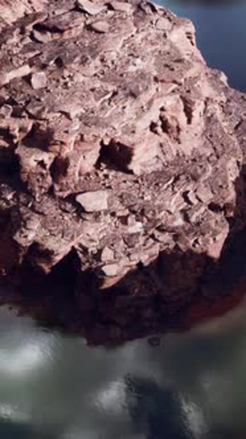 A Majestic Rock Rising From the Calm Waters of a Lake