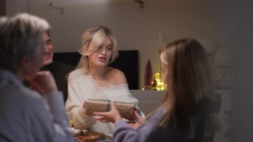 Tracking Shot of Smiling Loving Mother Giving Festive Box with Christmas Present to Adorable Happy