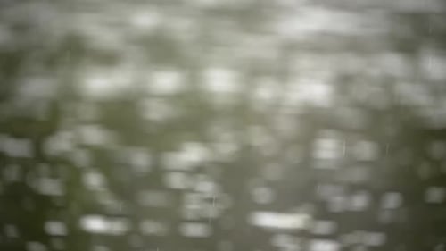 Rain Drops Falling onto Body of Water