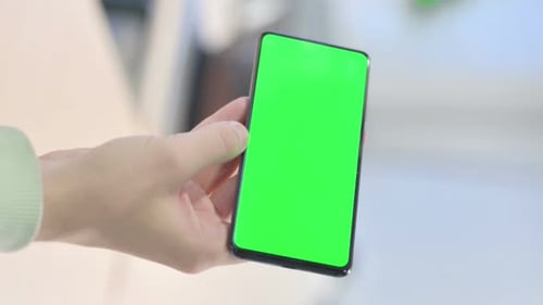Vertical Video of Young Man Watching Smartphone with Chroma Key