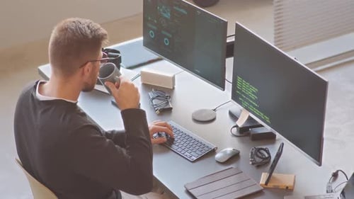 IT Specialist Working on Computer in Office