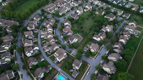 Aerial tilt up shot of modern housing area with one family homes in suburb. Rural landscape with new