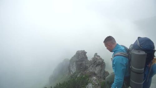 A Man in the Mountains in Cloudy Weather Stood on a Rock Rejoices in Victory