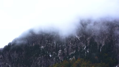 Dramatic winter scenery on high mountains of the Alps covered in fog, time lapse