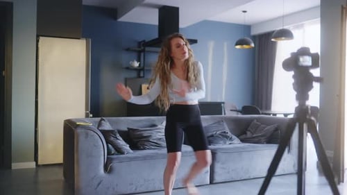 Woman Dancing and Recording Video in Modern Apartment