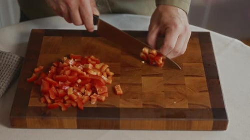 Hands Chopping Fresh Bell Peppers on Cutting Board