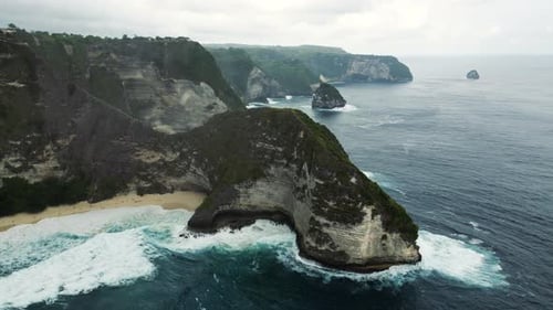 Aerial View of the Beautiful Nature of Kelingking Beach and Strong Coastal Waves