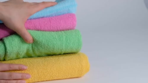 Hand Stacking Folded Colorful Rolled Up Towels