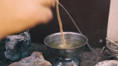 Jeweler Cleans Chain with Water on Table in Shop Closeup