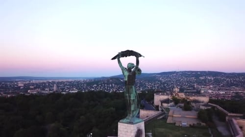 Budapest liberty statue and view of the early sun over the city