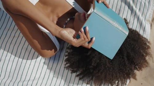 Playful Woman Reading on Summer Beach
