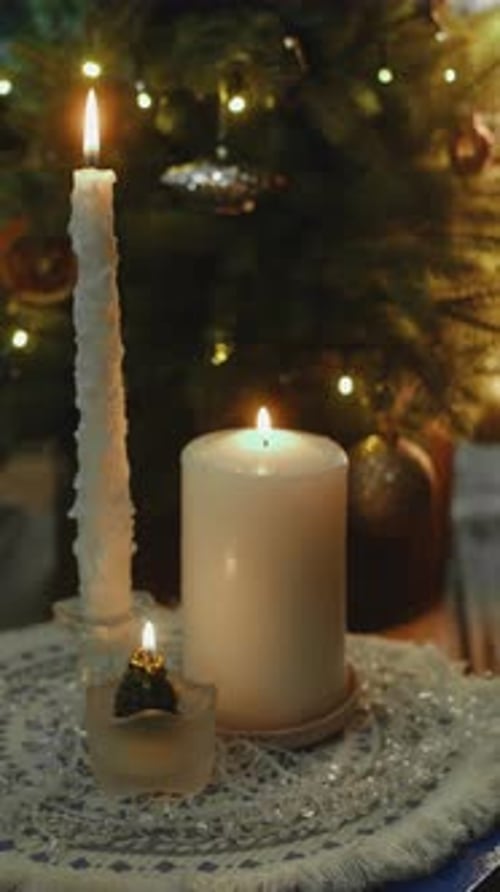 Vertical Video Christmas Candles Glowing Against Background of Christmas Tree