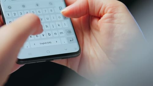 Hand Typing on Smartphone Screen Close Up
