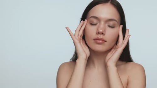 Woman Massaging Face for Beauty and Wellness