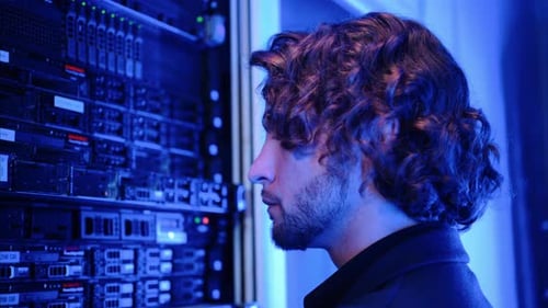 Man analysing servers in a data center