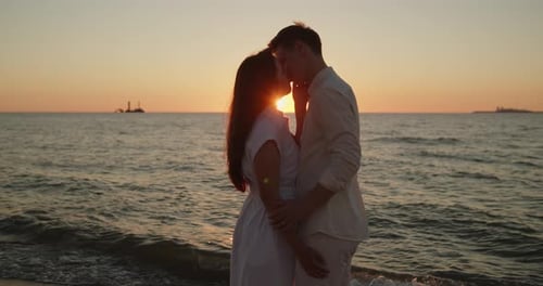 Couple Kissing in Sunset Light Standing Together on the Beach Closeup
