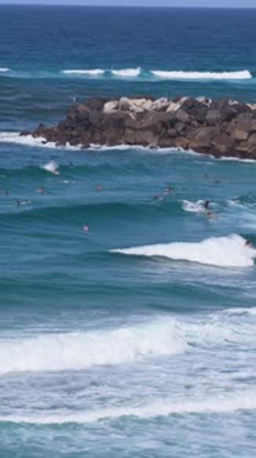 Surfers Surfing Ocean Waves In Tweed Heads, NSW, Australia - Vertical, Drone Shot