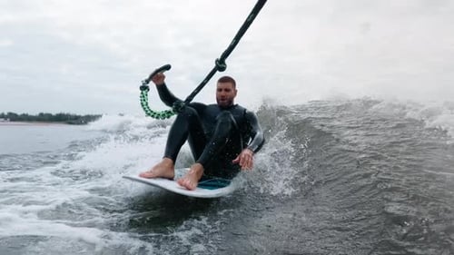 Man Wakesurfing on a Board in the Ocean