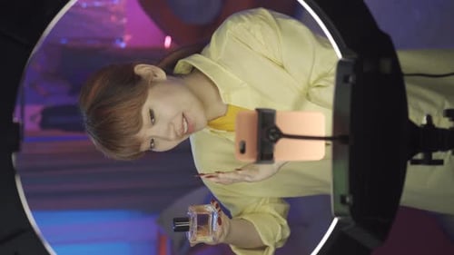 Young Adult Talks about Perfume in Vertical Video
