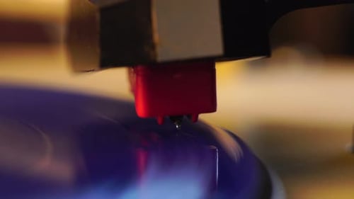 Crystal Gramophone Needle on Spinning Blue Vinyl Record, Close Up