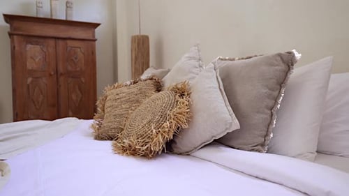 Relaxing Bed with Many Decorative Pillows