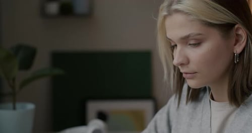 Young Adult Typing on Laptop at Desk