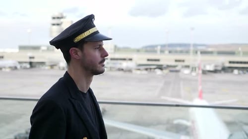 Handsome Pilot Observes Airport Activity