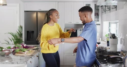 Happy Couple Dancing in Kitchen