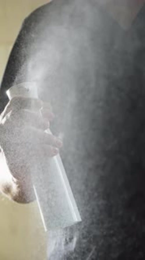 Closeup Sequence Showing a Person’s Hand Operating a Sleek White Trigger Spray Bottle Releasing a