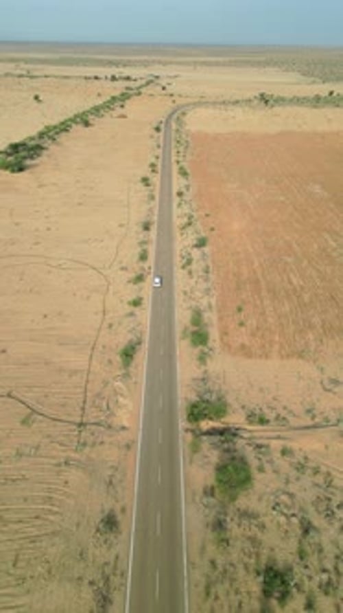 Car driving on Longewala road in Jaisalmer desert, Rajasthan – 4K Vertical drone