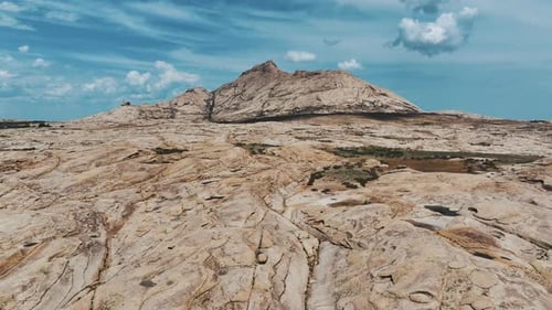 Rocky Mountain In A Desert Landscape. Stone Plateau Under A Blue Sky