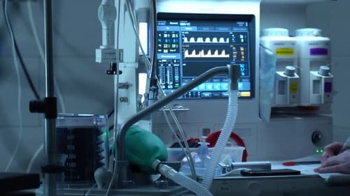 Medical Equipment Monitor and Technician Writing in Hospital