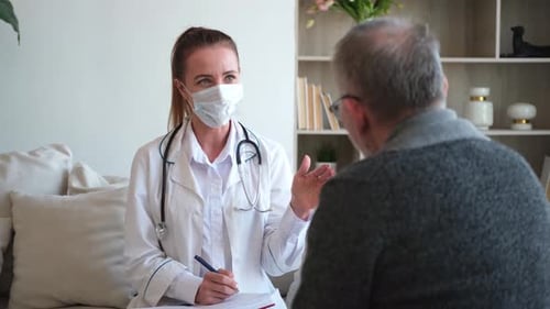 Female Doctor Examining Older Senior Man in Doctor Office or at Home