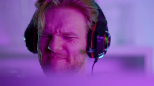 Disappointed gamer fail game in neon lights closeup at cyberspace studio tournament
