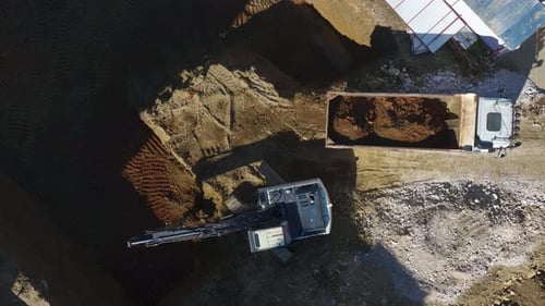 Aerial View of Excavator Loading Dump Truck with Dirt