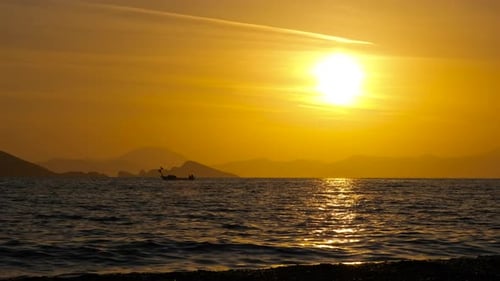 Boat Sailing on Ocean at Sunset