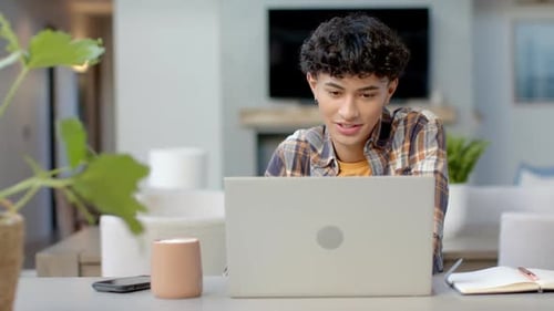 Teenage Boy Using Laptop at Home