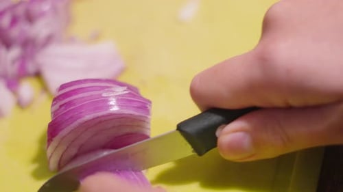 Dicing a Red Onion with Knife on Board