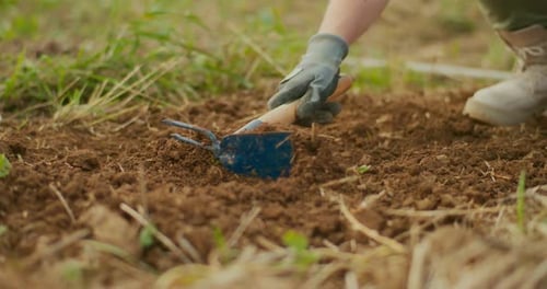 Hand Tilling Soil in Garden Close Up