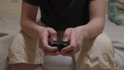 Man Playing Video Game with Controller Indoors
