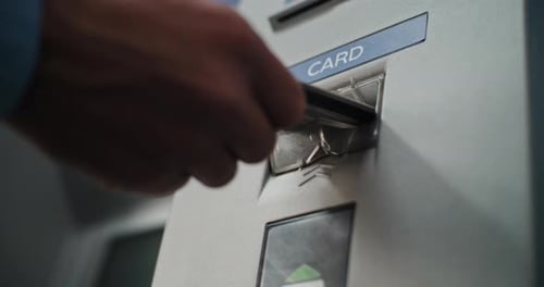 ATM Machine in Airport Terminal Close Up Shot of Person Inserting Plastic or Credit Card