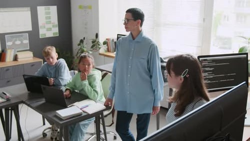 Teacher Listening as Student Answering Questions in School During IT Class