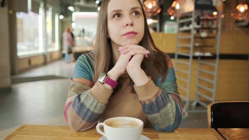 Morning Muse A Womans Coffee Delight A Woman with Long Brown Hair Sits at a Cozy Coffee Shop Table