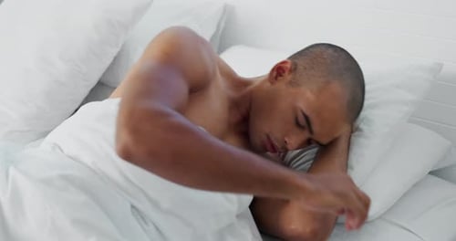 Man Sleeping Peacefully in Bed with White Bedding