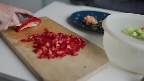Dicing Red Bell Pepper on Wooden Cutting Board