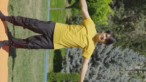 Young Man Doing Arm Stretches Outdoors