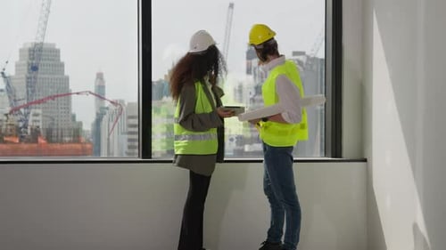 Group of professional engineers team working on construction site
