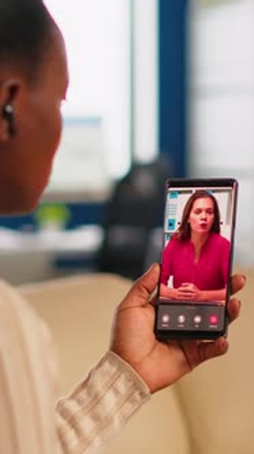Back View of African Woman Discussing with Remote Manager on Video Call