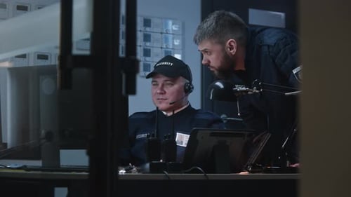 Two Security Officers Looking View From Security Cameras